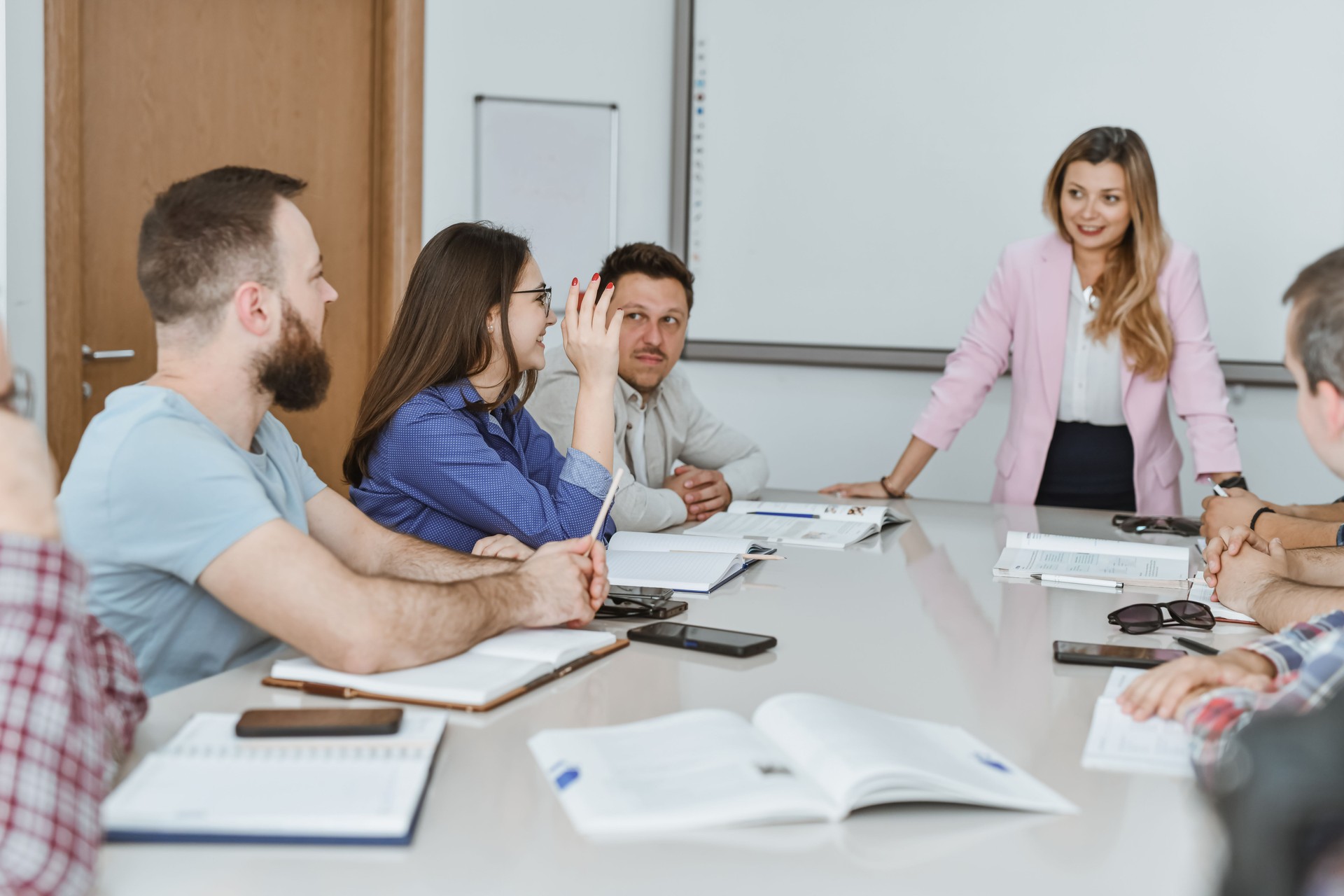 Female Student Raising Hand to Ask Question in English Class